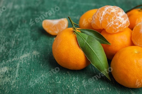 Preview: Fresh ripe tangerines with green leaves on table