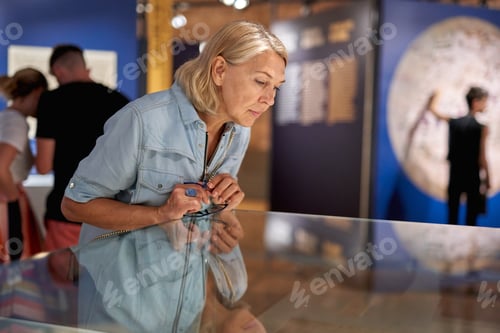 Preview: Woman Visitor In The Historical Museum Looking At Art Object