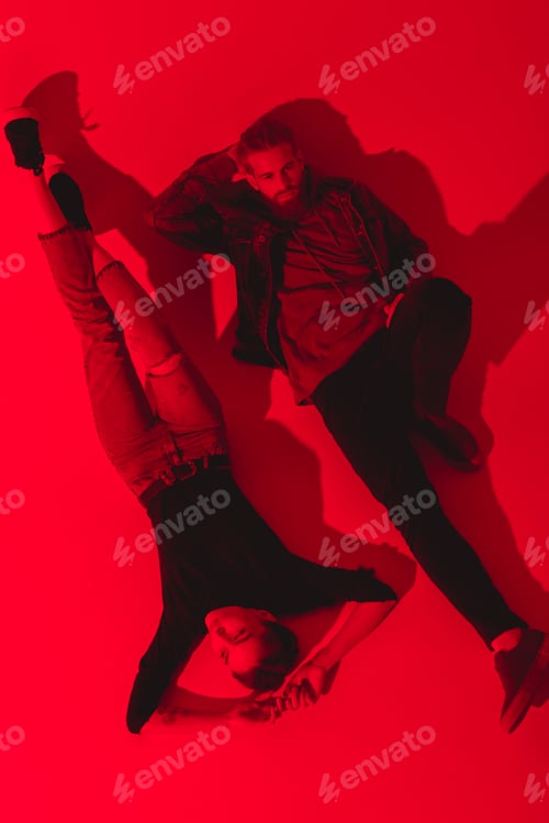 Preview: toned picture of stylish young couple lying on floor together