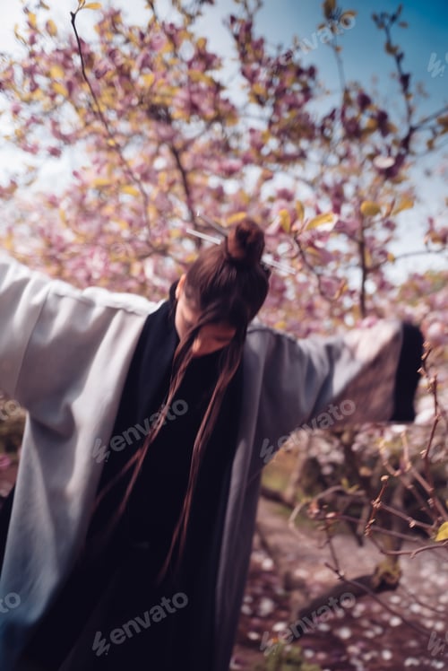 Preview: Beautiful young woman wearing kimono with cherry blossoms, sakura view