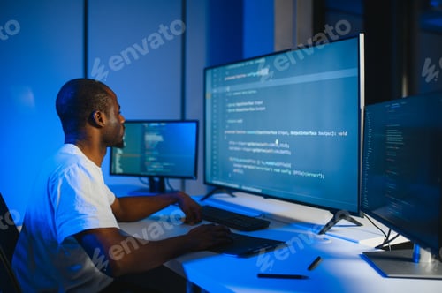 Preview: African american IT Programmer Working on Desktop Computer.