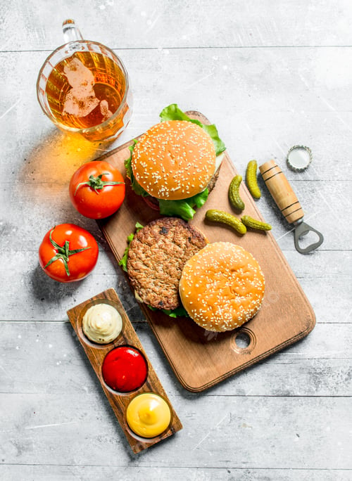 Preview: Burgers with beer,tomatoes and different sauces.