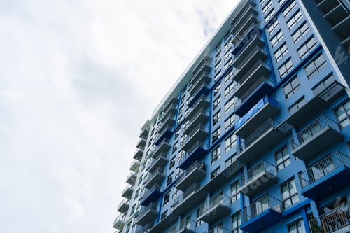 Preview: Blue facade modern condominium with balcony and glass windows