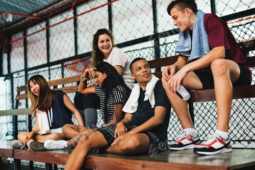 Preview: Group of young teenager friends sitting on a bench relaxing