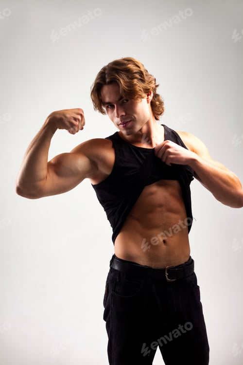 Preview: Lovely muscular man fashion model in blank black tank top showing muscles abs and arm biceps