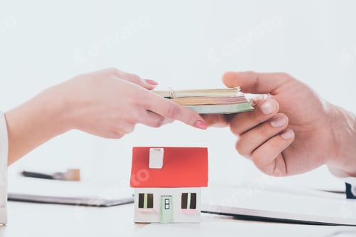 Preview: partial view of manager taking money from woman near house model