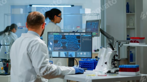 Preview: Man scientist working to develop a new vaccine in modern equipped laboratory