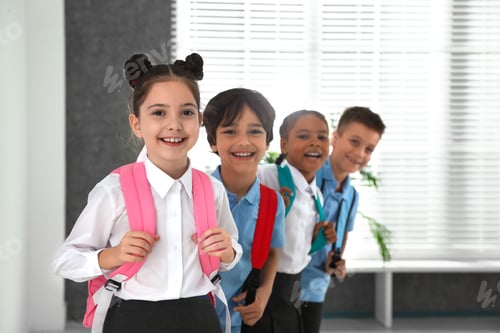Preview: Happy children in school uniform with backpacks indoors