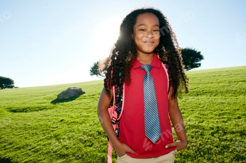 Preview: Young mixed race girl in pink shirt and formal tie, wearing a backpack