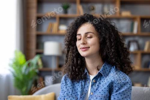 Preview: Woman meditating finding inner peace at home