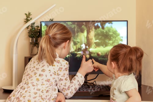 Preview: Two cute girls sisters play a video game and rejoice in the victory of their hero