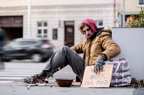 Preview: Homeless beggar man sitting outdoors in city asking for money donation.