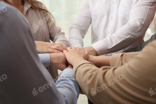 Preview: Group of people holding their hands together, closeup