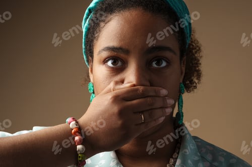 Preview: Young black woman in headband posing and covering her mouth