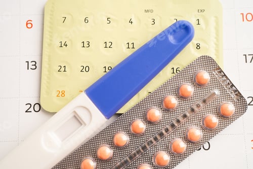 Preview: Pregnancy test and birth control pills on calendar, contraception health and medicine.
