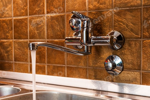 Preview: Tap water running from kitchen faucet