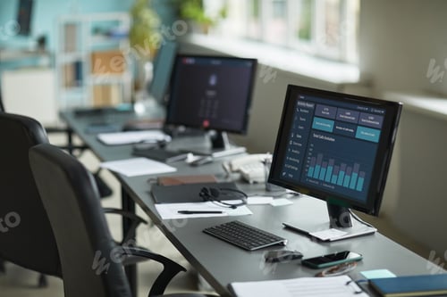 Preview: Modern Office Workspace Featuring Computer Monitors Displaying Data Analytics