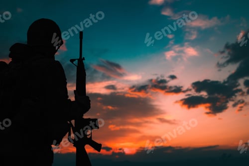 Preview: Silhouette of a military soldier with weapons at sunset