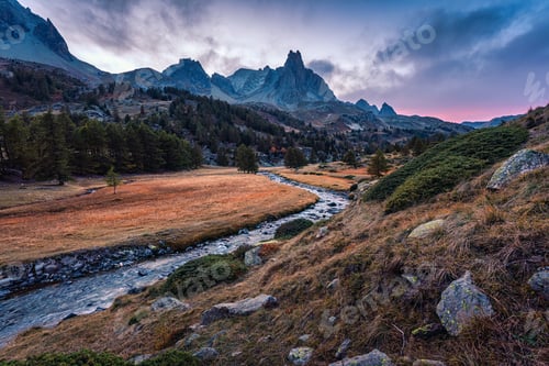 Preview: Sunset over Claree Valley with Main De Crepin peak and river flow during autumn at French Alps