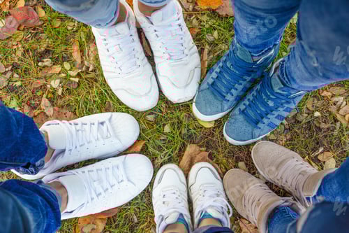 Preview: Legs of people in sneakers. The family walks in a circle. Team building team runs outdoors in autumn