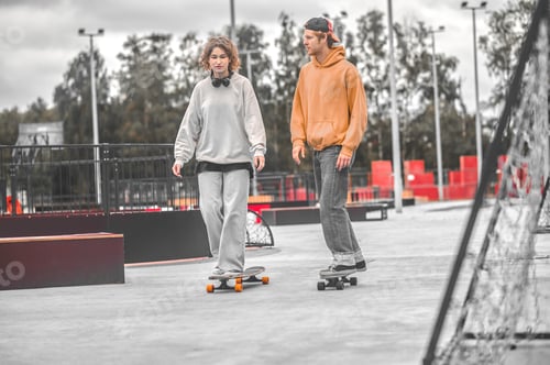 Preview: Guy and girl riding slowly on skateboards talking
