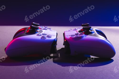 Preview: Composite of video game pads and copy space on neon background