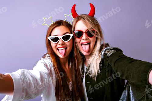 Preview: Young funny girls making selfie at studio making grimaces and going crazy