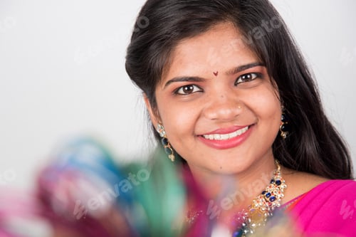 Preview: Happy young beautiful Indian woman in saree.