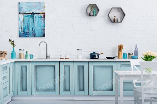 Preview: interior of modern turquoise kitchen with painting on white brick wall
