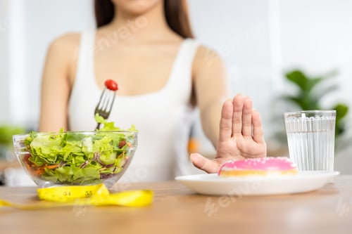 Preview: Close up hand of woman stop and using hand push out her favorite donut diet