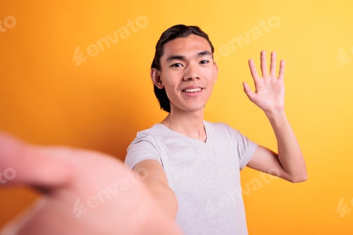 Preview: Smiling man talking on video call, waving hello