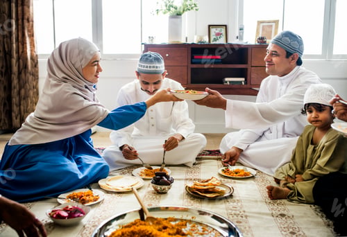Preview: Muslim family having dinner on the floor