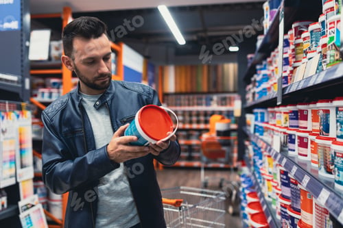 Preview: a man in a building hypermarket chooses facade paint