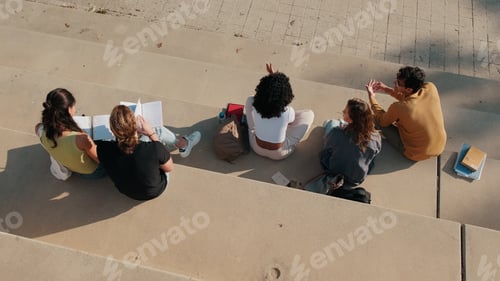 Preview: Group Of Students Studying On Outdoor Stairs Together