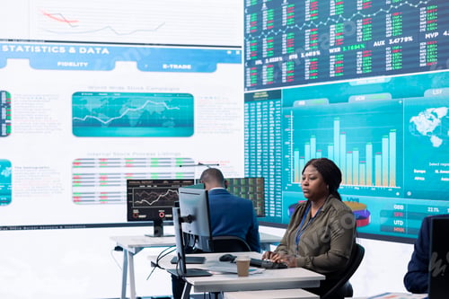 Preview: Chief executive officer reviews data shown on big display in the office