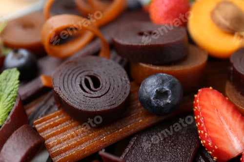 Preview: Tasty candied leather rolls, fruits and berries, closeup