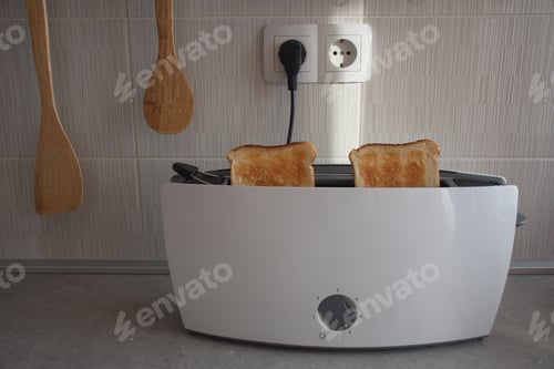 Preview: Toaster with baked toast on kitchen desk