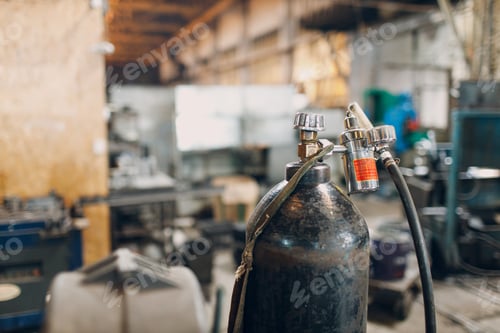 Preview: Iron gas cylinder for welding products on factory background.