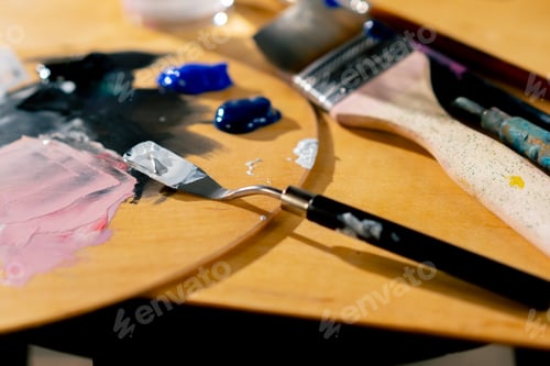 Preview: close-up in an art workshop there is a palette on stool palette knife a glass of solvent