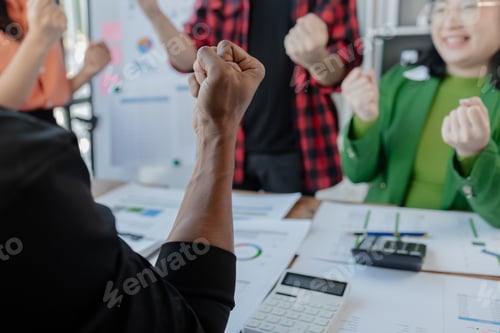 Preview: Joyful businesspeople freelancer entrepreneur smiling and rejoices in victory while sitting at desk