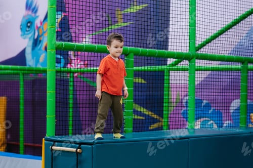 Preview: Cheerful little boy playing in the children's entertainment center.