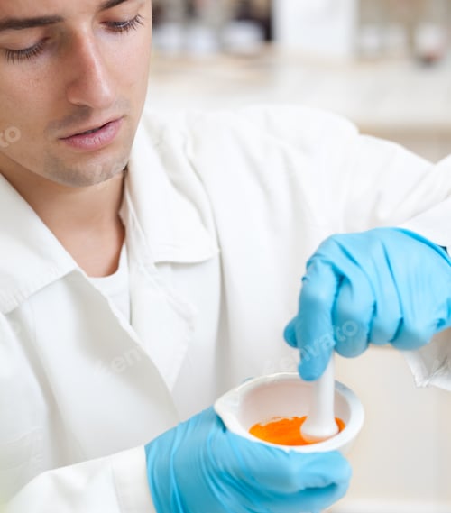 Preview: portrait of a young male researcher using a mortar and a pestle