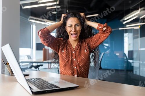 Preview: Angry businesswoman yelling at camera, latin american woman holding her head angry working inside