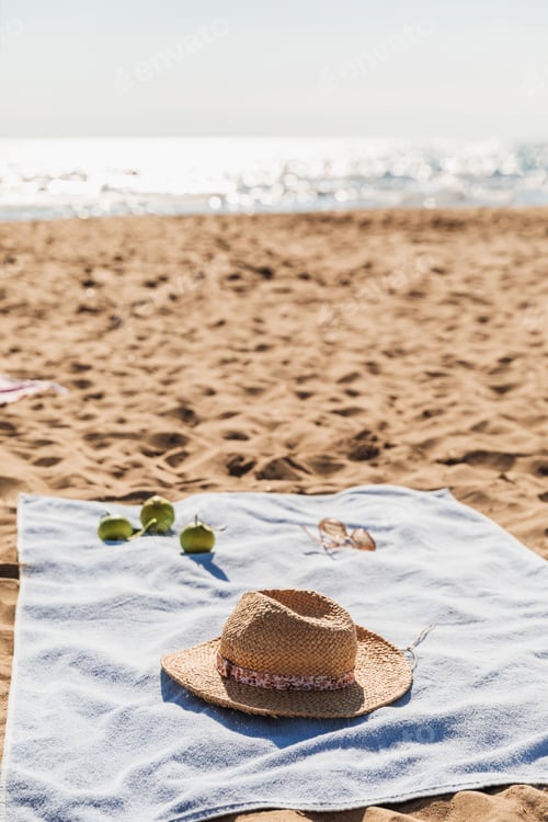 Preview: Summer beach accessories on sand background. Holiday travel, tropical concept.