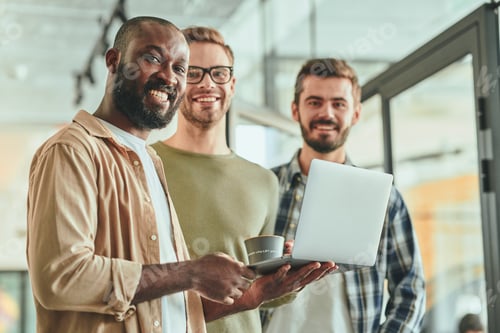 Preview: Three young multiracial working men posing for camera