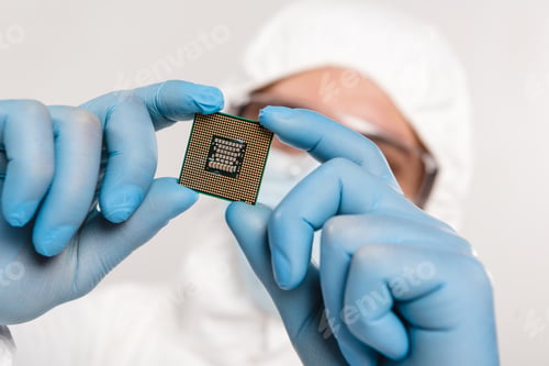 Preview: selective focus of microchip in hands of scientist wearing latex gloves isolated on grey