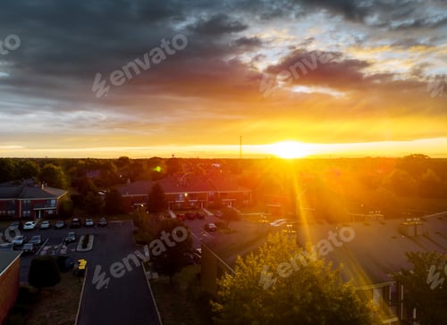 Preview: Aerial top down view flying over appartments in small town showing roofs of houses early sunrise