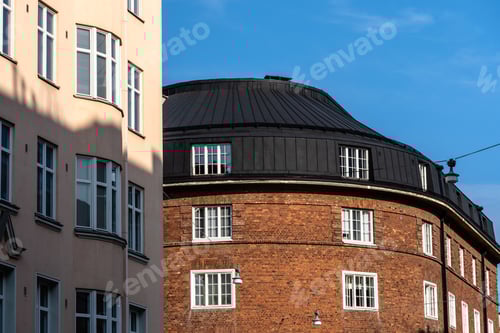 Preview: Architectural beauty in Helsinki: A blend of brick buildings under a clear blue sky.