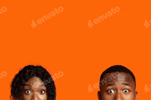 Preview: Shocked black couple with big eyes hiding from someone