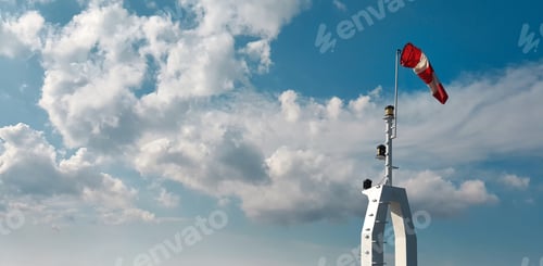 Preview: Windsock indicator of wind on sky background